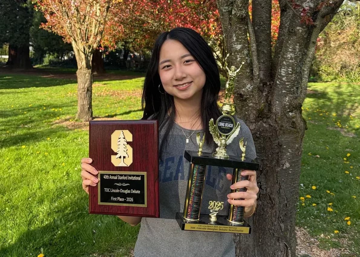 Shiwen Huang with Stanford trophies