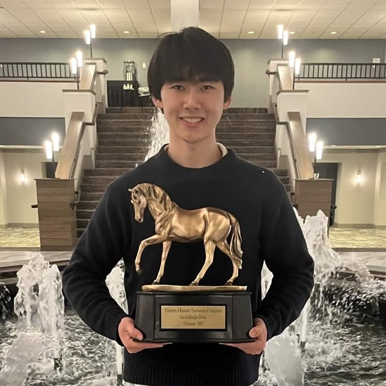 Bolang Zhu holding his TOC champion trophy